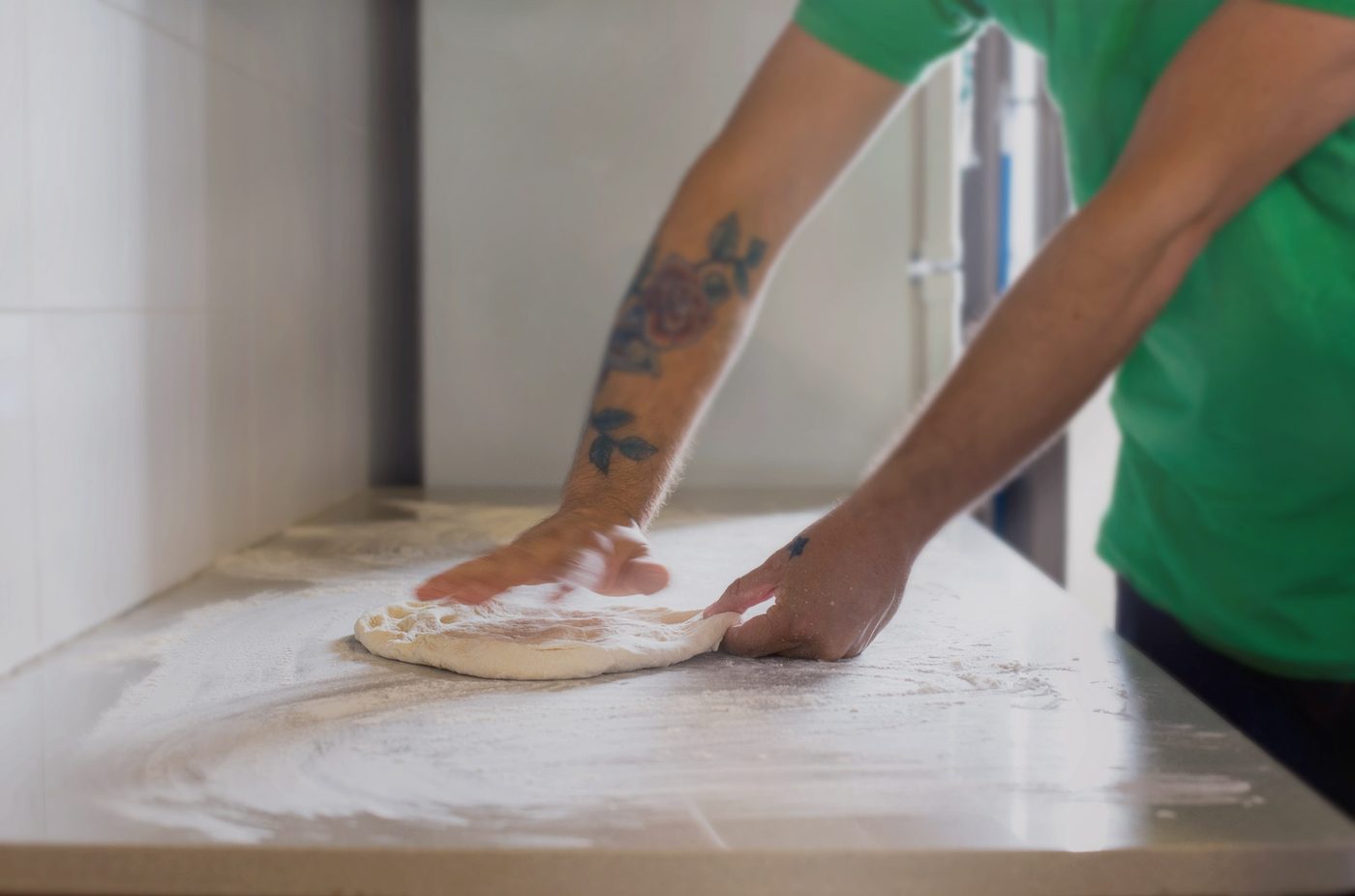 Stretching pizza dough by hand
