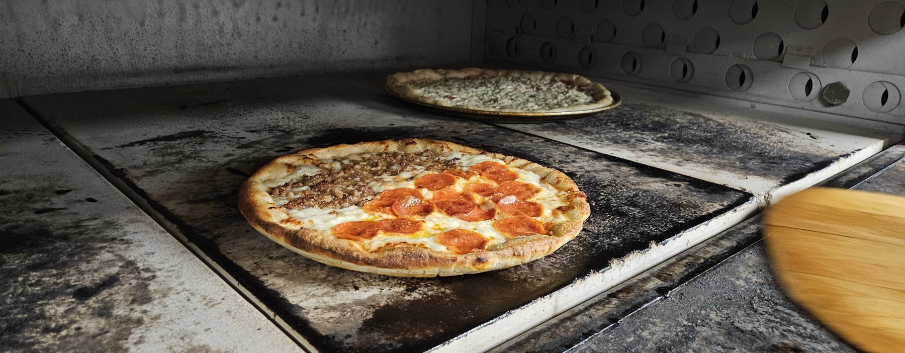 Pizza baking on the oven stone
