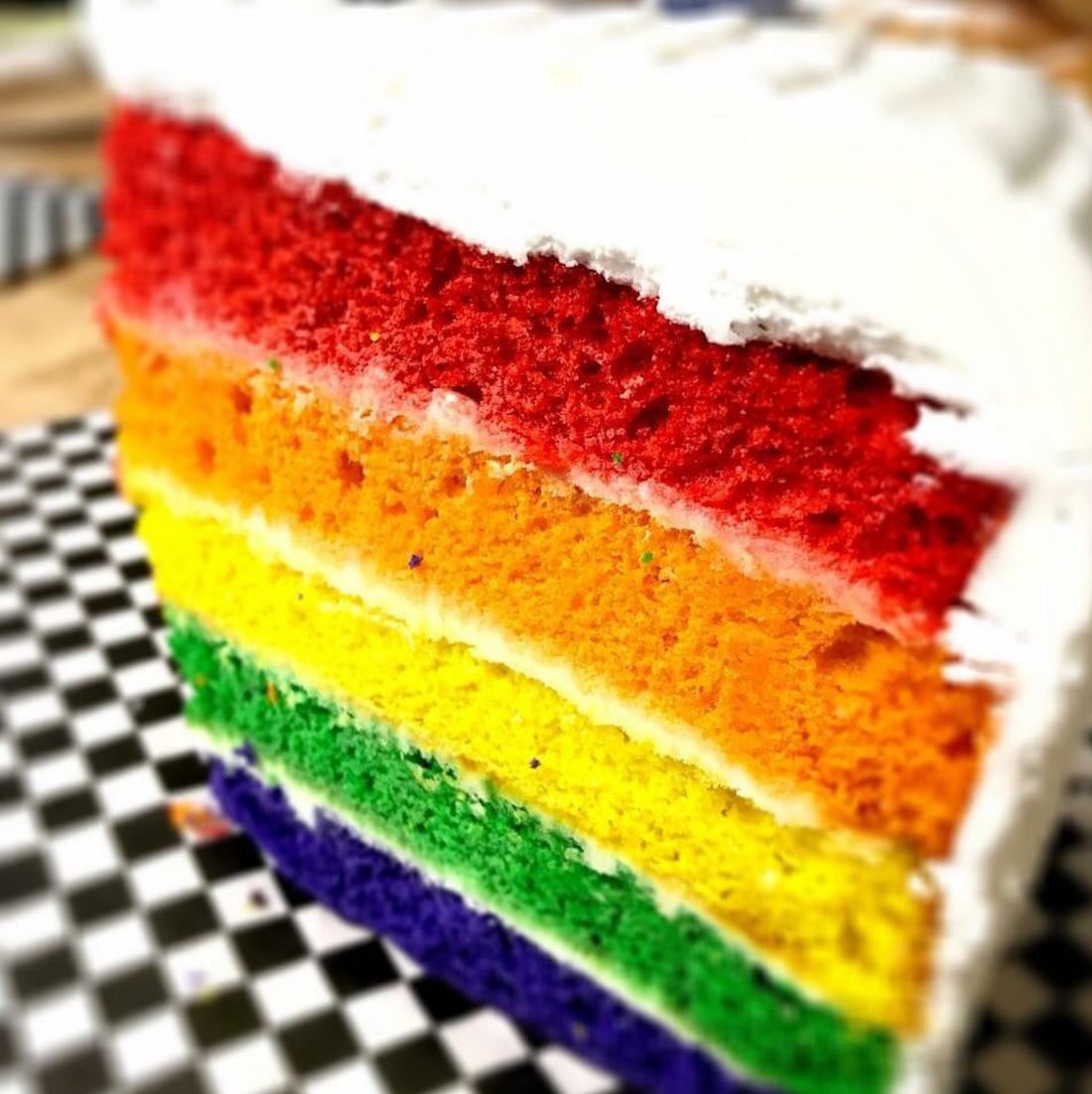 Layered rainbow cake slice