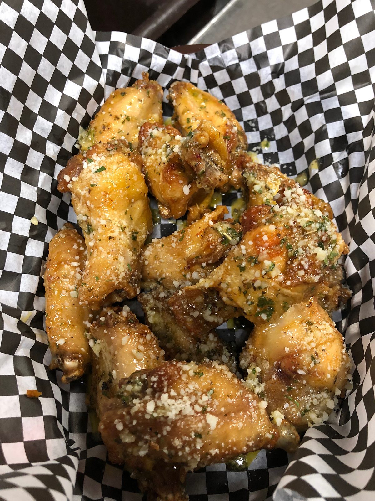 Garlic parmesan wings in a checkered basket
